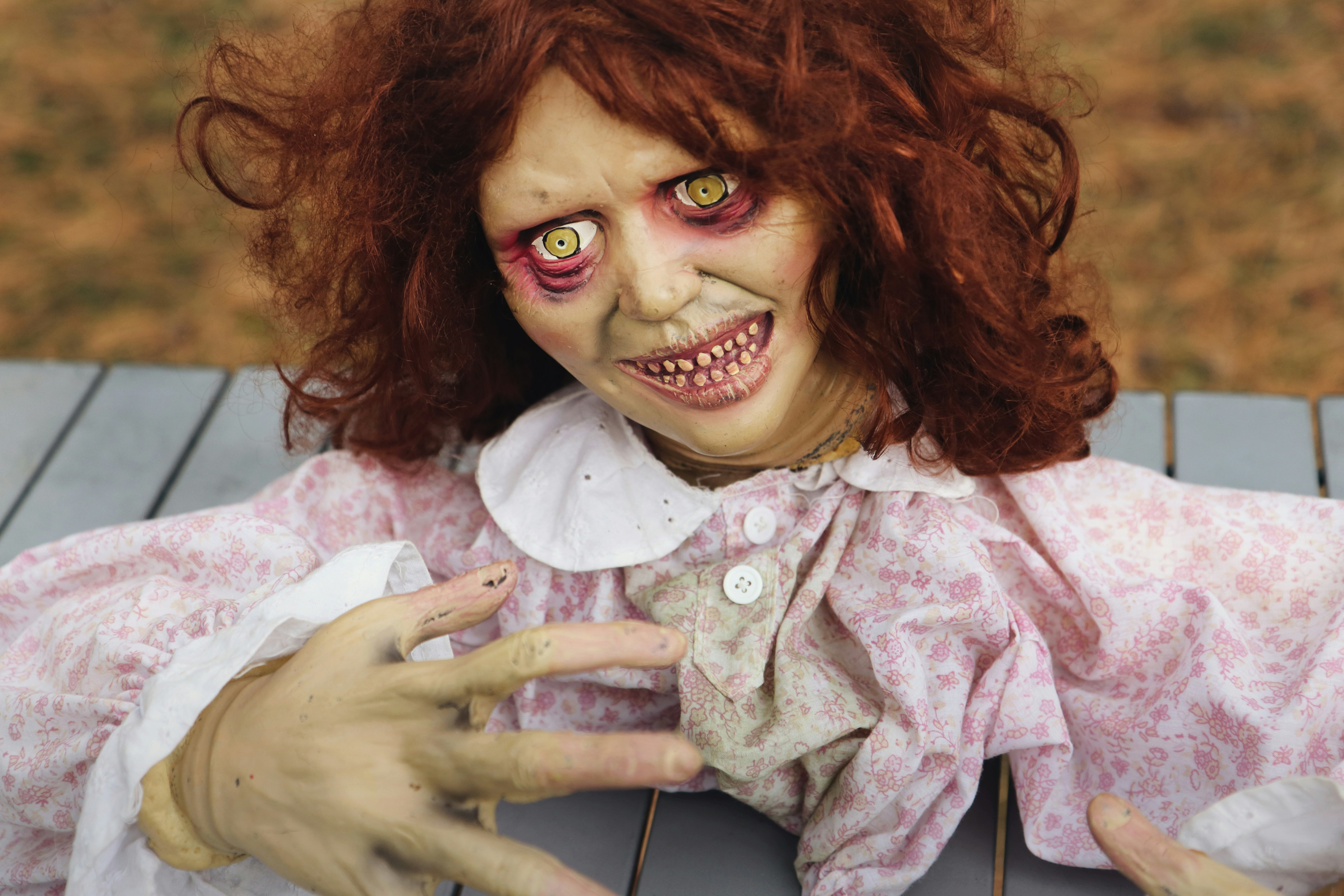 a photo of a super creepy doll puppet with hair and dead eyes