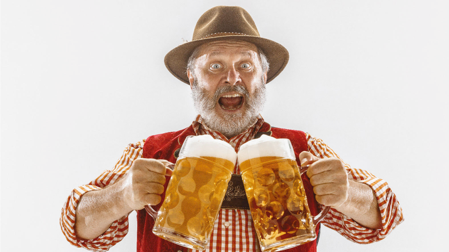 Happy man holding two pints of beer